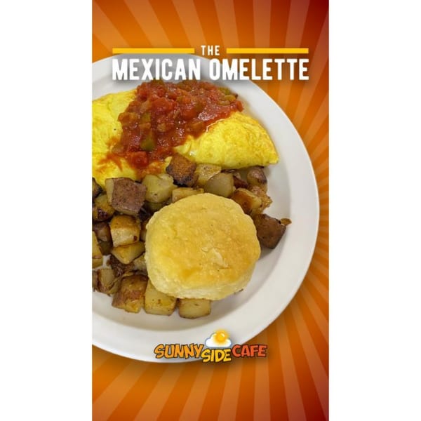 A Sunnyside Cafe Mexican Omelette with salsa, home fries, and a biscuit on a white plate.