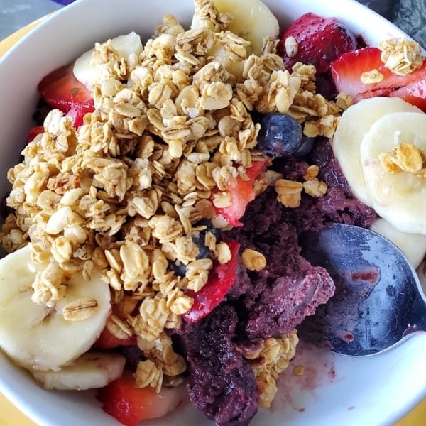 Sunnyside Cafe's acai bowl with granola, sliced bananas, strawberries, and blueberries.